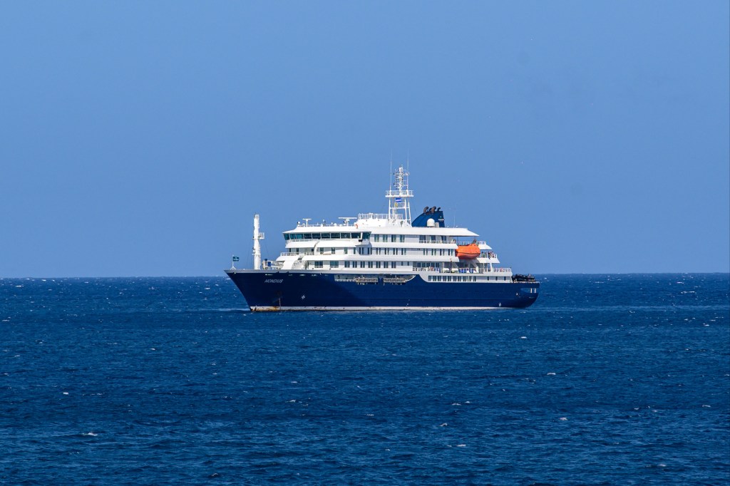 A general view of the cruise ship MV Hondius stationary off the port of Praia, the capital of Cape Verde, on May 3, 2026. An outbreak of "severe acute respiratory illness" on board a cruise ship in the Atlantic has left two people dead and a third in intensive care in Johannesburg, South Africa's health ministry told AFP on May 3, 2025.