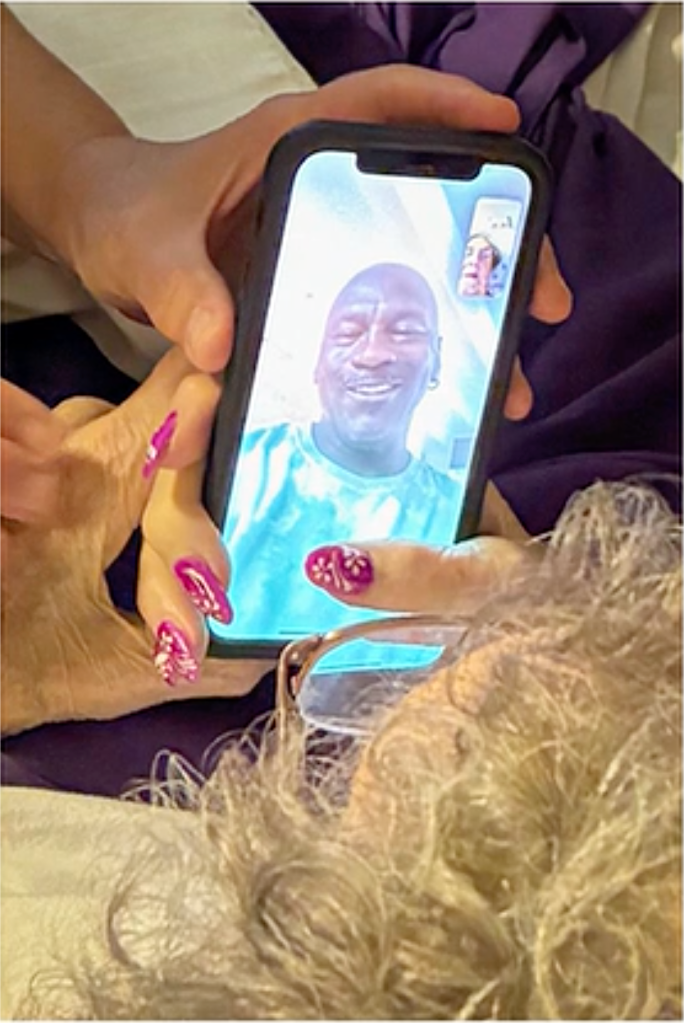 Michael Jordan on a video call on a smartphone.