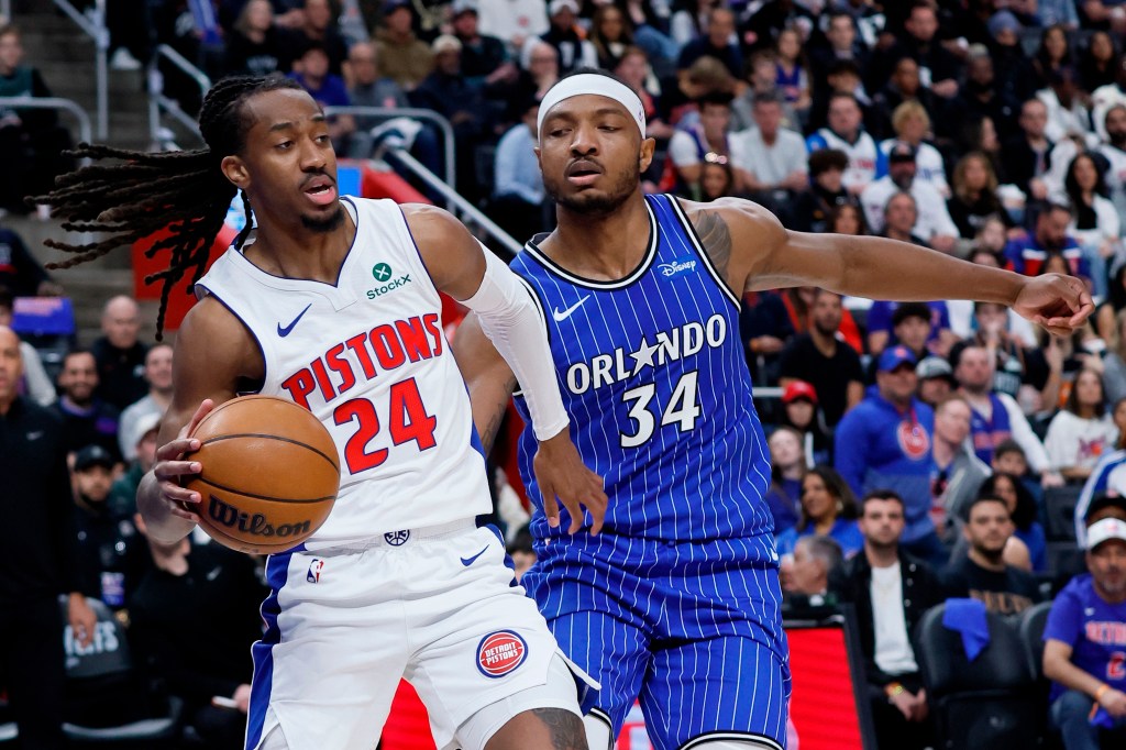 Detroit Pistons guard Daniss Jenkins (24) drives past Orlando Magic center Wendell Carter Jr. (34).