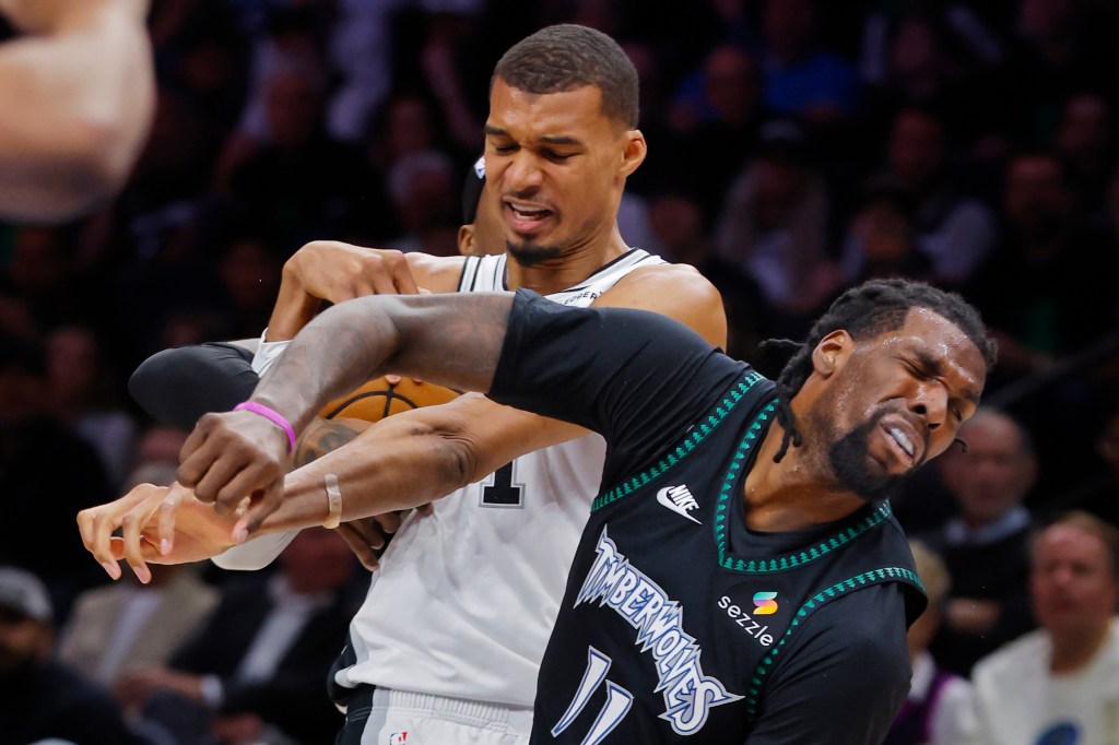 Victor Wembanyama committing a flagrant foul on Naz Reid during a basketball game.
